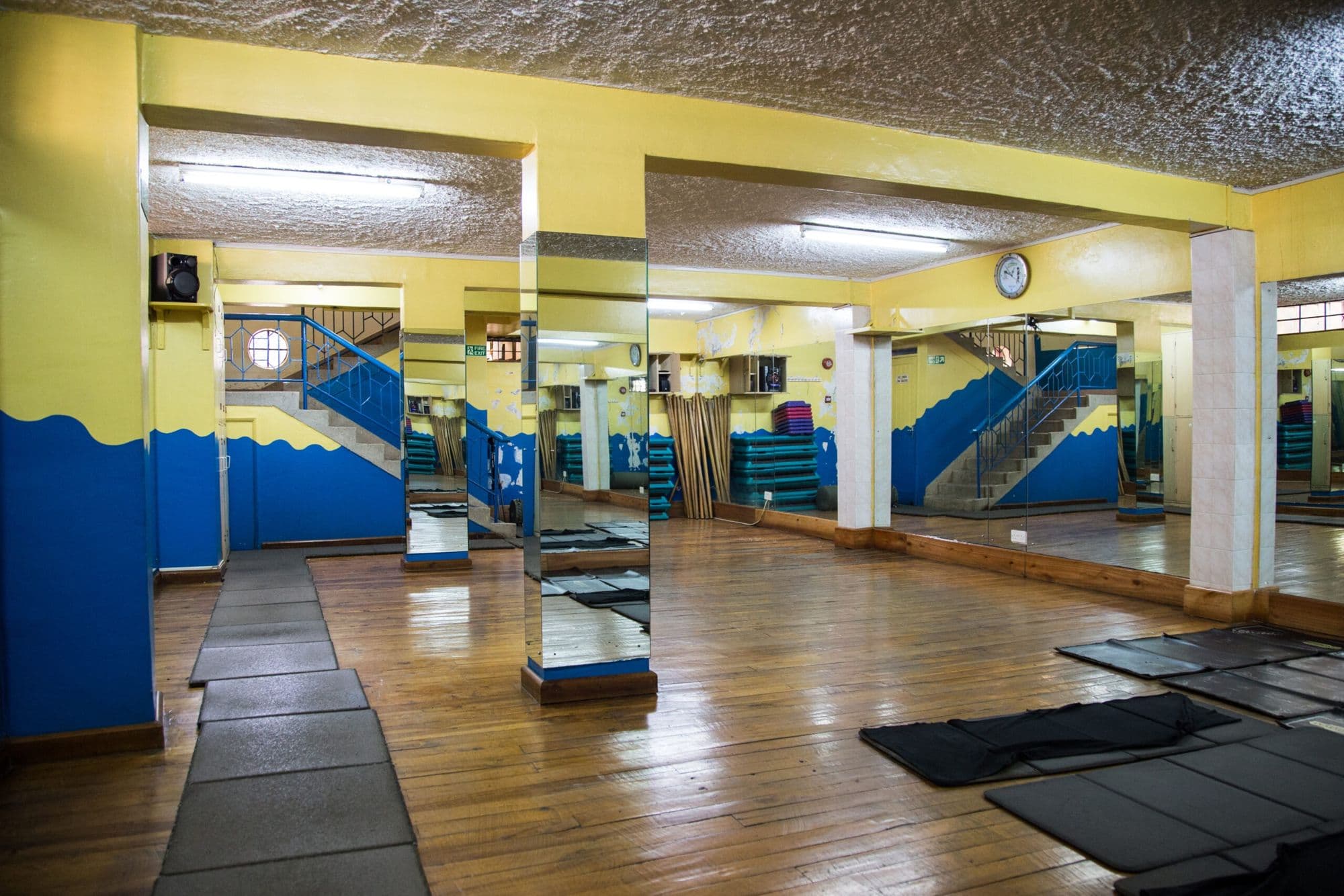 The exercise studio with mats and a mirrored wall