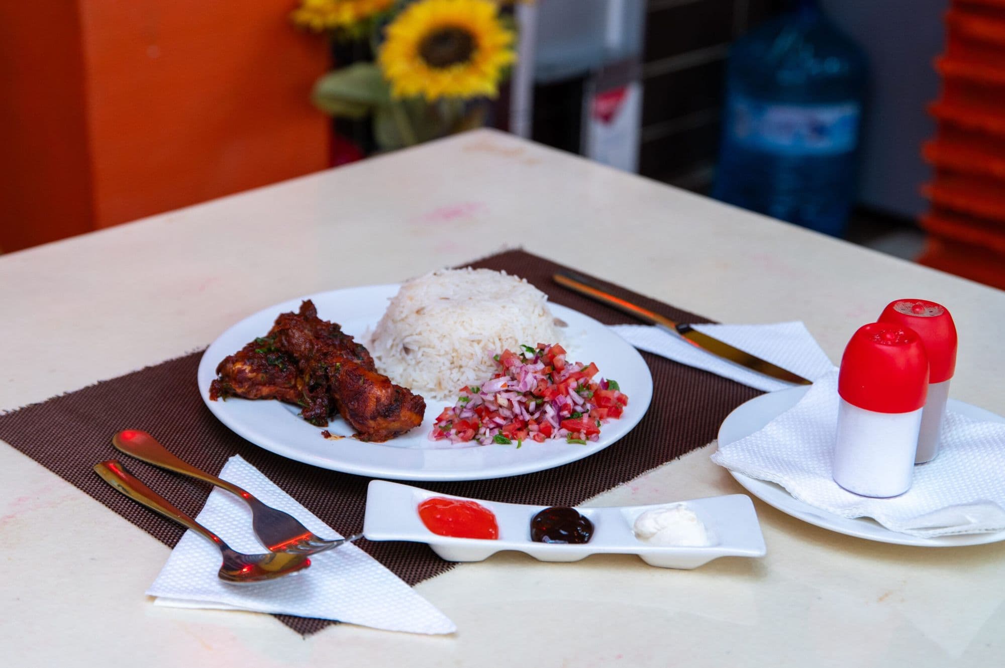 Grilled chicken, rice and kachumbari at Sunflower Restaurant